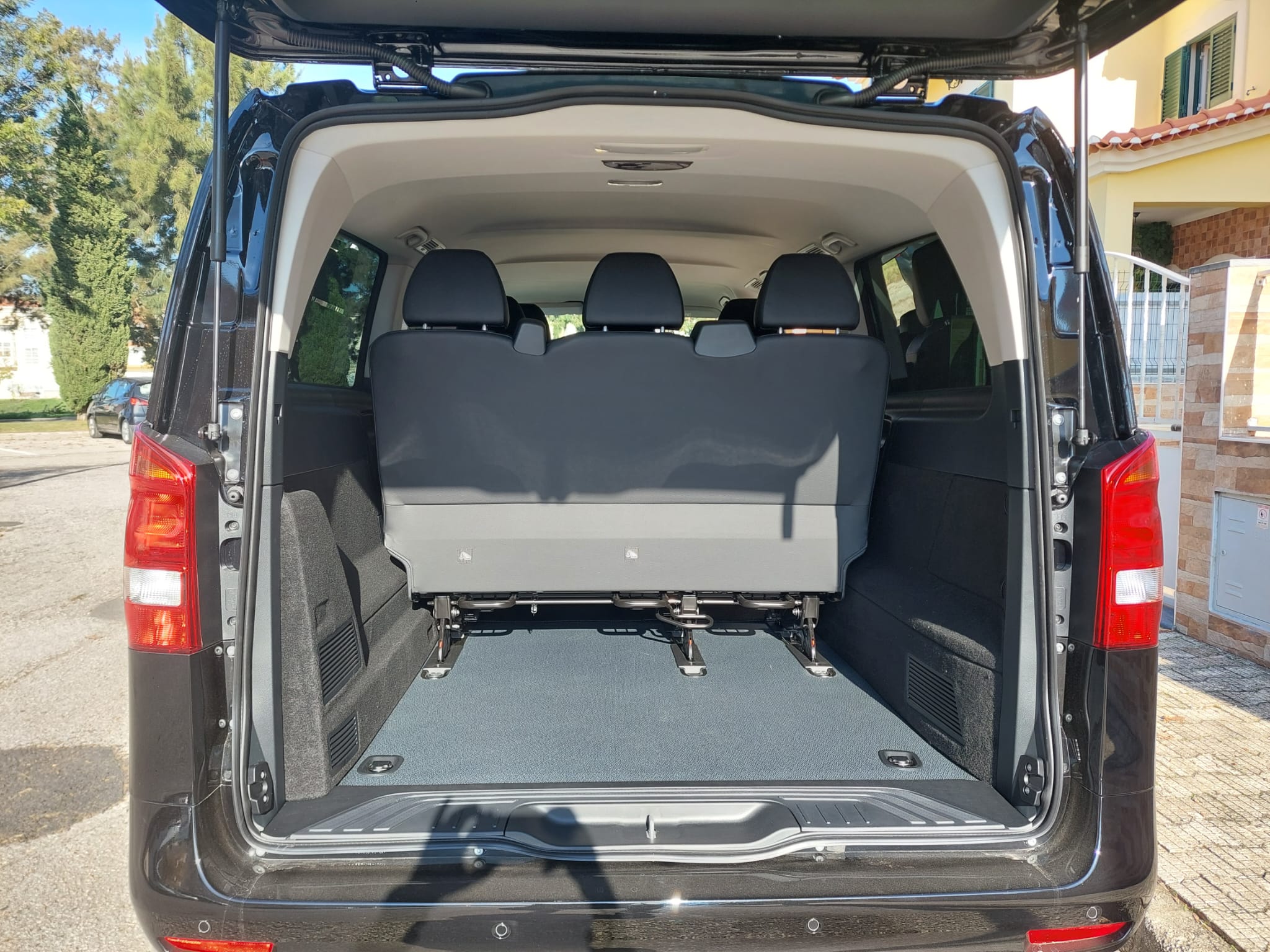 Open luggage area at the rear of a Selective Travel van