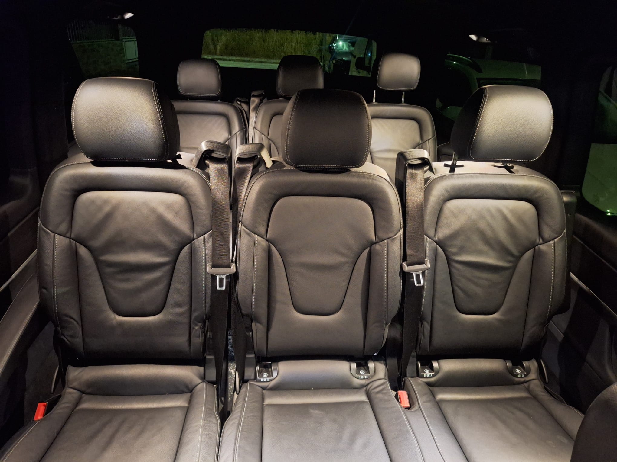 Rows of passenger seats inside the Mercedes van